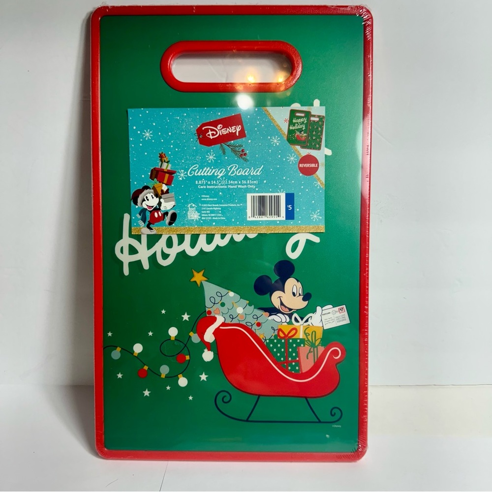NWT. Disney holiday cutting board. Plastic reversible cutting board